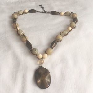 Beaded necklace with larger pendant.